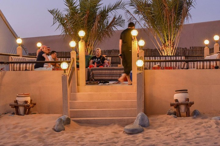 Experience the magic of Dubai's desert with a delightful BBQ dinner under the stars featuring traditional dance performances Arabic coffee and relaxed moments in a cozy camp setting.